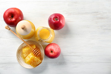 Composition with honey and fruit on wooden background