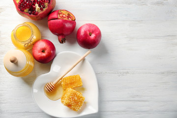 Composition with aromatic honey and fruits on wooden table