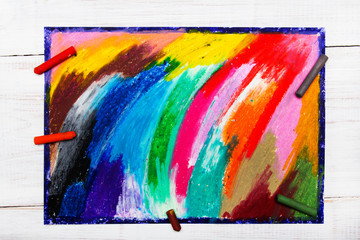 oil pastels drawing and crayons on wooden background