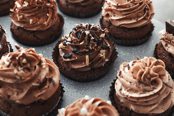 Muffin tin with tasty chocolate cupcakes, closeup