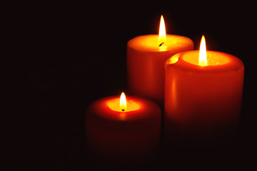 Burning candles on dark background