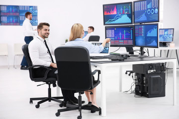 Stock traders working in office