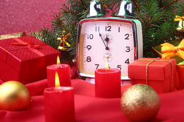 Christmas vintage clock and candles. New Year's Decoration with gift boxes, christmas balls and tree. Celebration Concept for New Year.