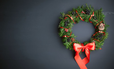 Christmas wreath on a wooden background © Mykhailovskyi