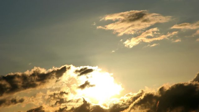 Time Lapse of the sun rising behind clouds.
