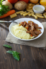 Soy meat with potato puree over kitchen table.