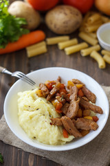 Soy meat with potato puree over kitchen table.
