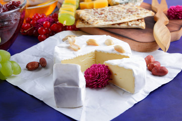 Cheese, camembert, wooden board, pear, Christmas cheese, honey, cherry jam, green grapes, dark blue background, pop art, red berries, Mexican cuisine, Indian cuisine, art