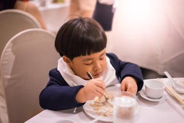Obraz na płótnie Canvas A boy is eating food.