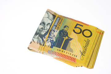 Stack of fifty Australian dollar bills on white background.