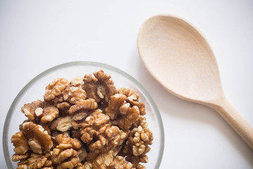 Walnuts / healthy nuts on the bowl and wooden spoon