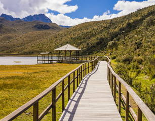 Fototapeta na wymiar Wooden walkway crossing Limpiopungo Lagoon, Cotopaxi National Park, Ecuador 