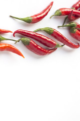 Red chile peppers on white background. Top view. Vertically
