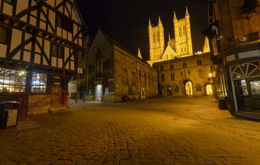 Medieval Part of Lincoln by night, Bailgate and Exchequer Gate Street Crossing, Night view over Timber Frame Building and Cathedral Towers behind Exchequer Gate