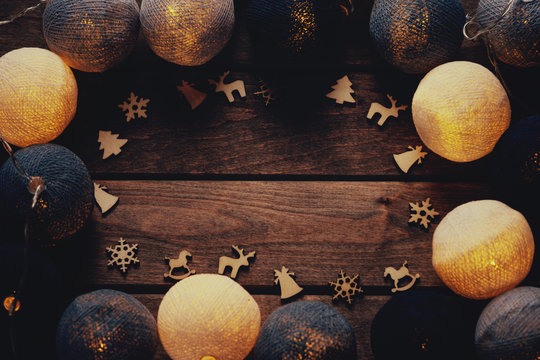 Beautiful lanterns garlands like balls and christmas decoration over wooden background 