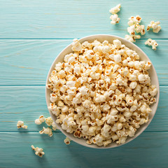 Cheddar cheese popcorn in a white bowl - obrazy, fototapety, plakaty