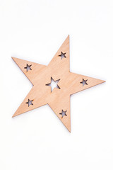 Christmas wooden decoration star. Cut out wooden figure of star isolated on white background, top view. New Year handicraft.
