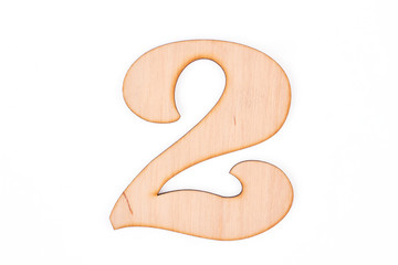 Cutout number two on white background. Wooden carved number two isolated on white background.