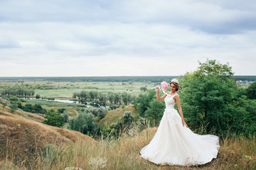 Fototapeta na wymiar Beautiful young bride girl smiling, standing in wedding dress.