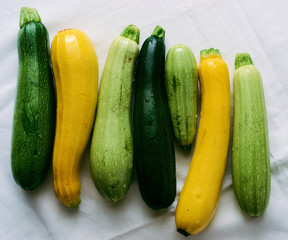 Raw healthy organic zucchini on white background top view 