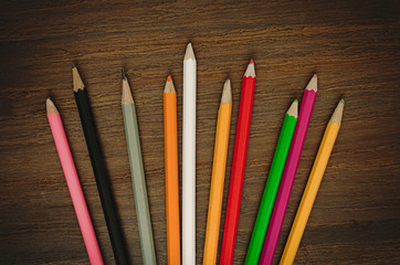 Colorful pencils on wood table top view 