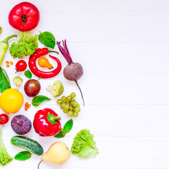 Healthy new year concept - fresh organic vegetables, herbs and fruits in the form of part of x-mas tree on white wooden background. Diet, detox planning. Top view. Selective focus. space for text.