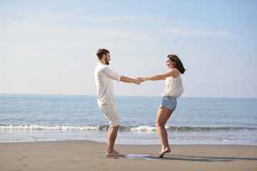 Fototapeta na wymiar happy young romantic couple in love have fun on beautiful beach at beautiful summer day.