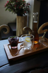 Berries tea with ice ball on wood background