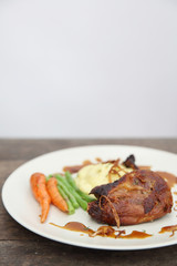 duck confit , Grilled duck steak with carrot and asparagus on wood background