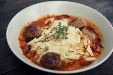 Pasta meatballs tomato sauce on wood background