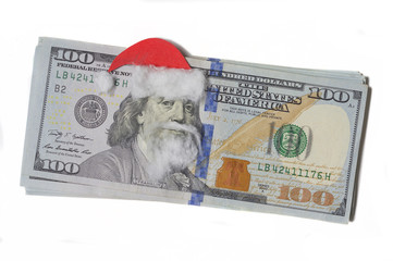 Benjamin Franklin in a Santa Claus hat on a banknote isolated a white background