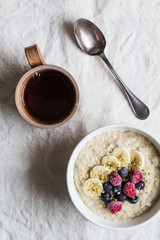Obraz na płótnie Canvas Porridge with spoon and tea