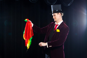 Magician, Juggler man, Funny person, Black magic, Illusion focus with colored cloth with cloths