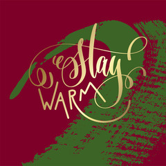 stay warm - gold hand lettering on green and purple brush stroke