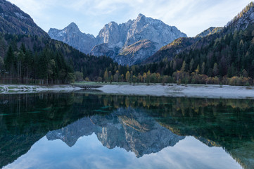 Fototapeta na wymiar Wonderful shot of the Julian Alps reflecting into the Lake Jasna in Slovenia's Kranjska Gora region