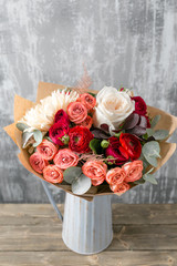 beautiful luxury bouquet of mixed flowers in vase . the work of the florist at a flower shop. copy space