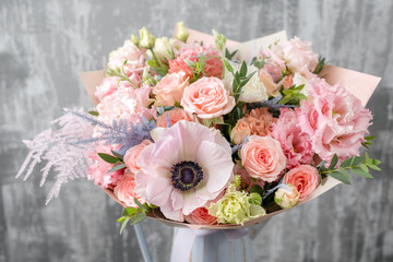 beautiful luxury bouquet of mixed flowers in vase . the work of the florist at a flower shop. copy space
