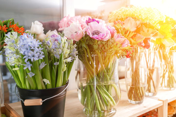 different varieties. Fresh spring flowers in refrigerator for flowers in flower shop. Bouquets on shelf, florist business.