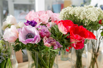 different varieties. Fresh spring flowers in refrigerator for flowers in flower shop. Bouquets on shelf, florist business.