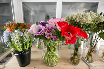 Fototapeta na wymiar different varieties. Fresh spring flowers in refrigerator for flowers in flower shop. Bouquets on shelf, florist business.