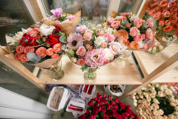 different varieties. Fresh spring flowers in refrigerator for flowers in flower shop. Bouquets on shelf, florist business.