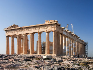 Early morning light and blue skies illuminate the Parthenon a top the Acropolis in Athens, Greece.