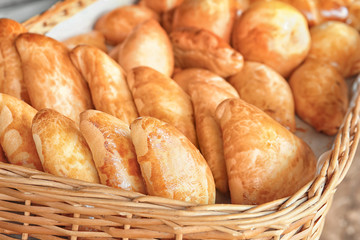 Fresh tasty bakery products in wicker basket