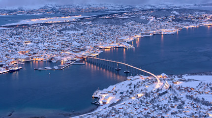 Tromso the northern most town of norway covered in snow during dark december winter