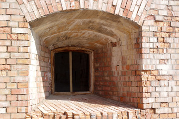 Fototapeta na wymiar One window of the old brick fortress