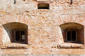 Fototapeta na wymiar Two windows of the old brick fortress