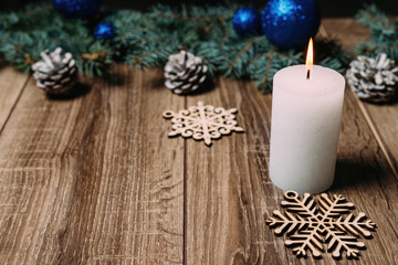 Fototapeta na wymiar christmas candle on a wooden background