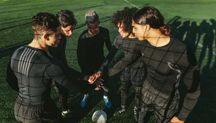 Foto op Canvas Five a side football team putting their hands together © Jacob Lund