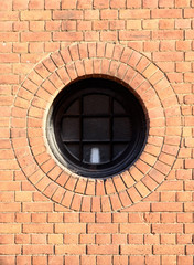 Round Window in Red Brick Wall