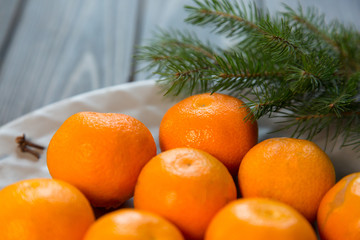 a plate of tangerines stay on the wooden table. new year concept.